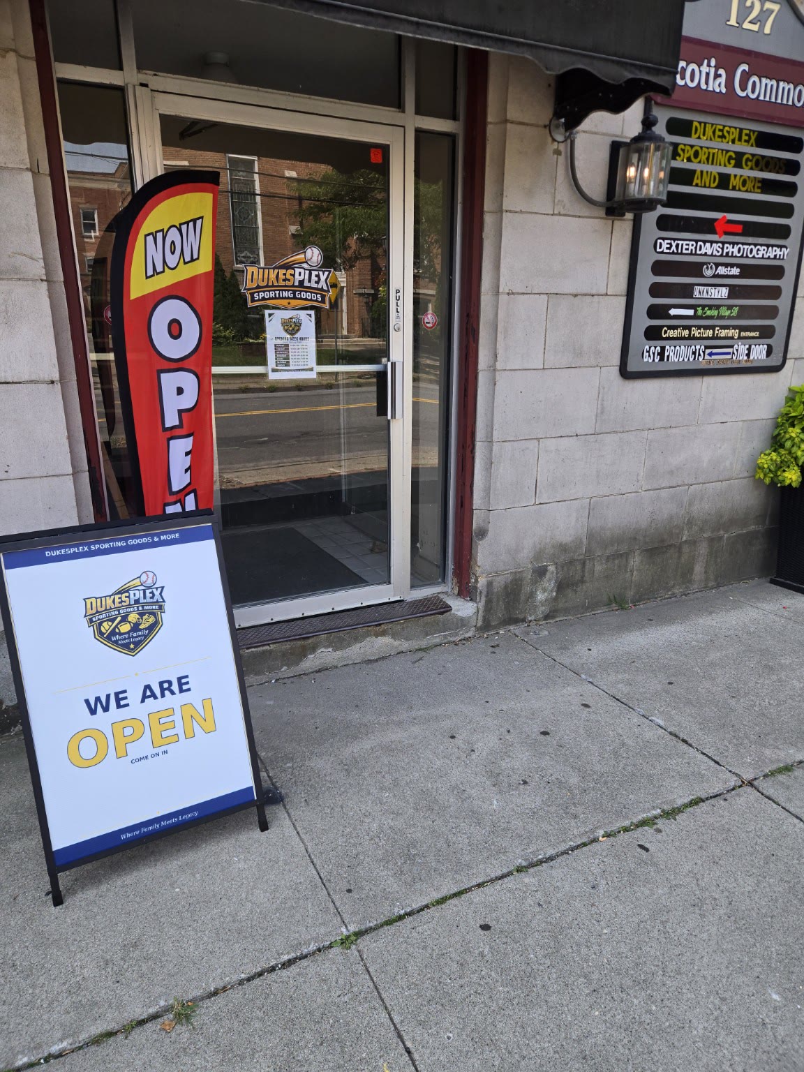 DukesPlex storefront at 127 Mohawk Ave, glass door and open sign